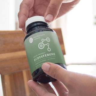 Person holding a bottle of vegan-friendly Ecdysterone capsules from Neurogan Health.