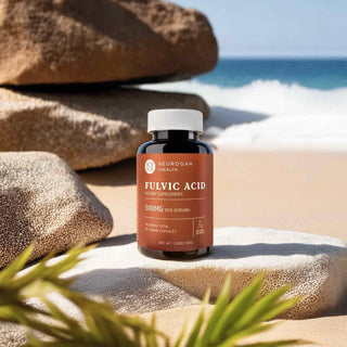 Fulvic Acid bottle positioned on a beach with rocks and ocean waves in the background, capturing a natural setting.