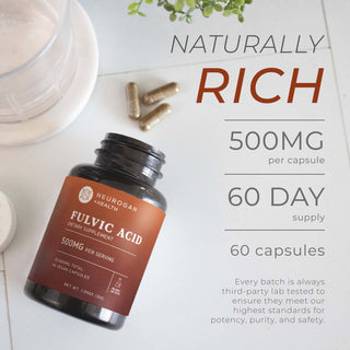 Fulvic Acid Capsules bottle with loose capsules on a white tile surface, texts showing total content per bottle.