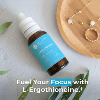 L-Ergothioneine Drops bottle on a table, promoting focus and vitality with 11.6mg per serving.