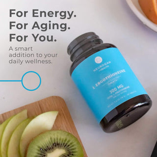 L-Ergothioneine Tablets bottle on a countertop with fruits, promoting energy and wellness.
