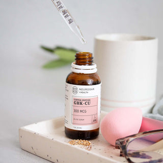 Copper peptide GHK-Cu serum bottle with dropper, showcasing skincare essentials and beauty tools.