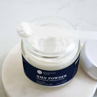 Open jar of NMN Powder with a scoop of white powder.
