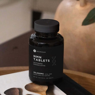 Neurogan NMN tablets bottle, 30,000mg nicotinamide mononucleotide, dietary supplement on a wooden surface.