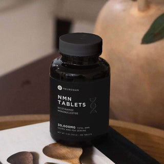Neurogan NMN tablets bottle, 30,000mg nicotinamide mononucleotide, dietary supplement on a wooden surface.