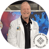 Smiling professor in a white lab coat, standing in front of a colorful medical backdrop with virus imagery.