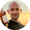 Man holding CBN oil bottle against a sunset backdrop, showcasing hemp-derived wellness products.