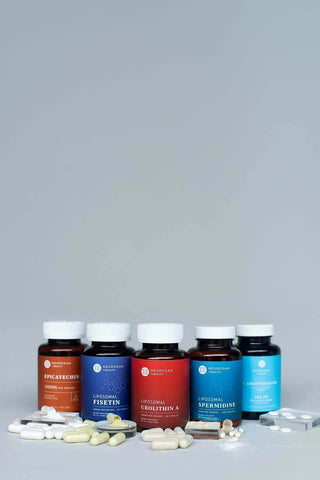 Five bottles of dietary supplements and pills, featuring Epicatechin, Fisetin, Urolithin A, and Spermidine.