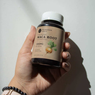 Hand holding a Neurogan Health Maca Root supplement bottle, 1300MG serving size, natural health product.
