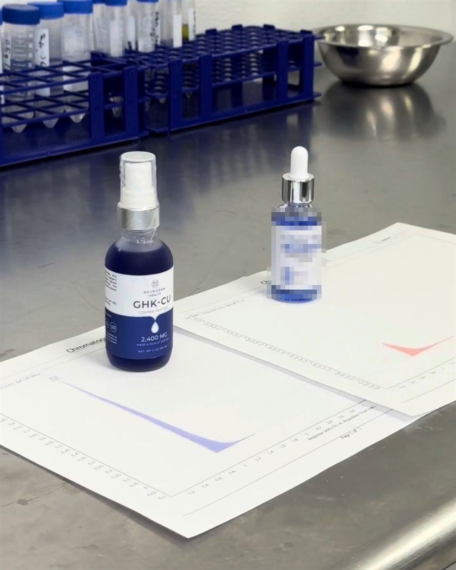 Our GHK-Cu serum next to another brand's bottle on lab printouts