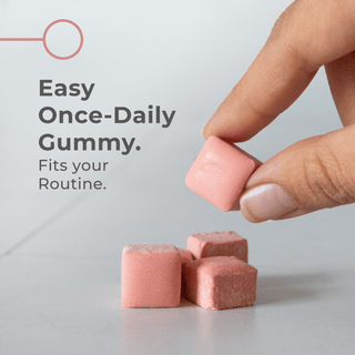Urolithin A Gummies in a hand, showcasing strawberry-flavored easy once-daily gummy that fits your routine.