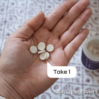 Hand holding NADH tablets, 20mg per tablet, with text indicating to take one tablet per serving.