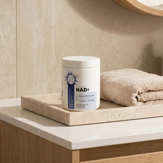 Liposomal NAD+ Capsules 500mg on bathroom counter with towels, promoting health and cellular energy.