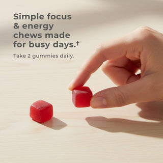 Hand holding NMN Gummies with text promoting focus and energy chews for busy days.