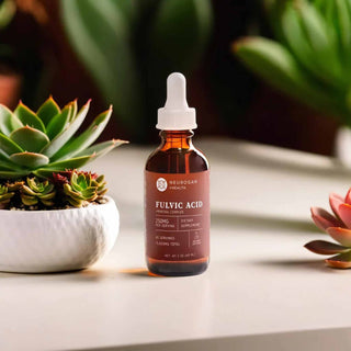 Fulvic Acid Drops bottle next to succulents, promoting nutrient absorption and digestive wellness*.