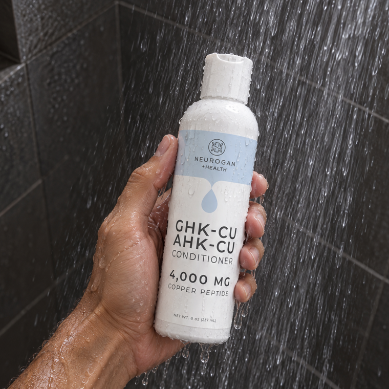 Holding the GHK-Cu + AHK-Cu Conditioner in the shower