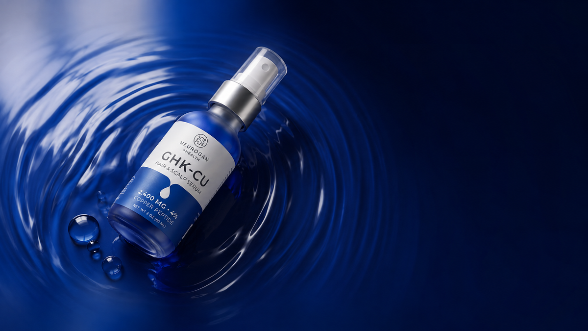 GHK-Cu Hair & Scalp Serum spray bottle resting in rippled blue serum