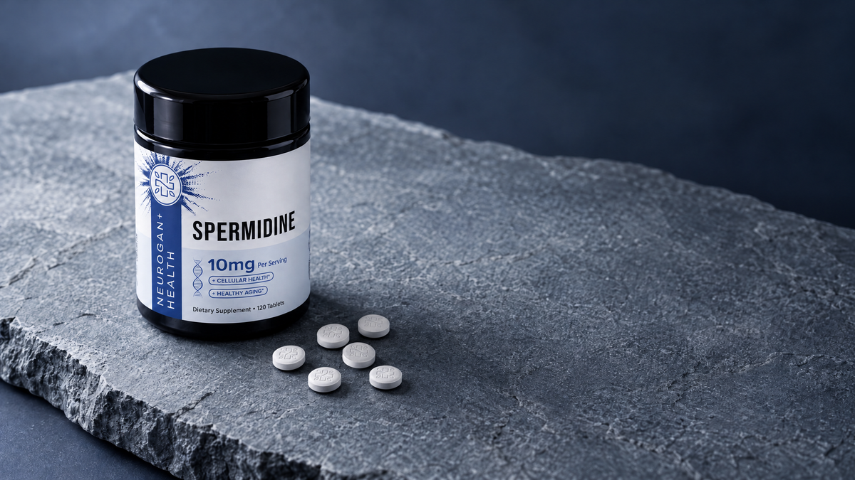 Spermidine Tablets jar on blue-grey stone beside white tablets