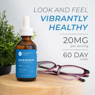 Spermidine Drops 2400mg bottle on a table with glasses, promoting 20mg per serving and 60-day supply.
