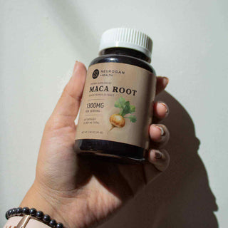 Hand holding a Neurogan Health Maca Root supplement bottle, 1300MG serving size, natural health product.