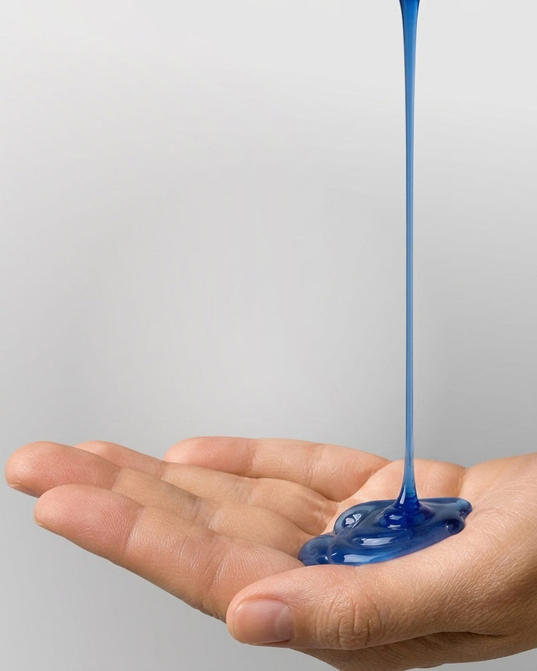 Blue GHK-Cu + AHK-Cu Shampoo poured into a cupped palm